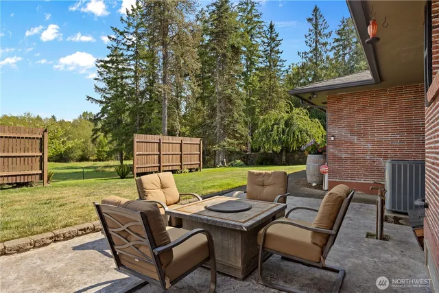 a backyard of a house with barbeque oven and brick wall