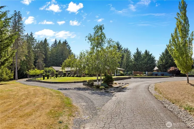 an aerial view of a house with swimming pool patio and lake view
