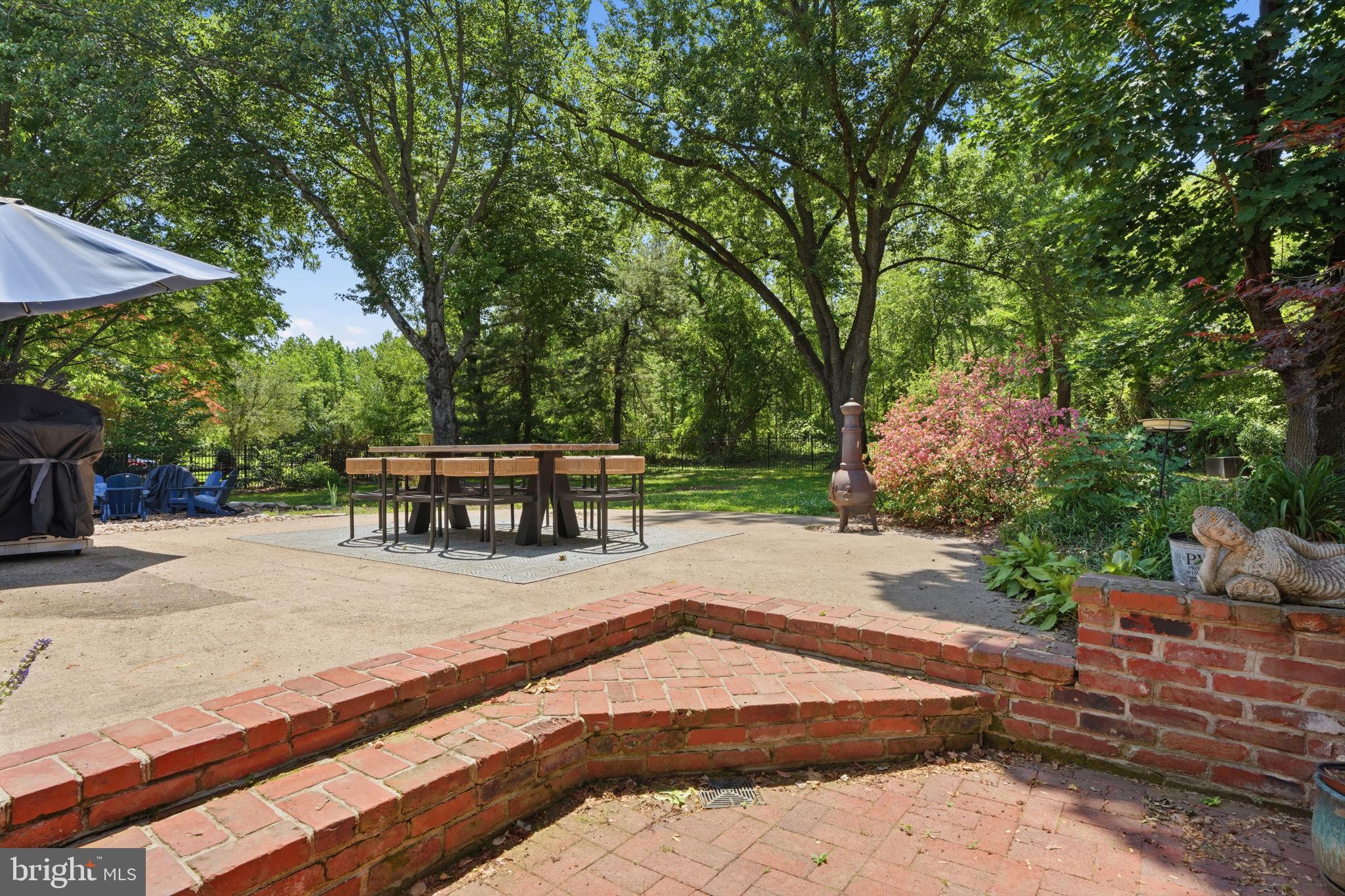 621 River Road Yardley, PA 19067 - Photo 55 of 75 a view of a patio with table and chairs under an umbrella