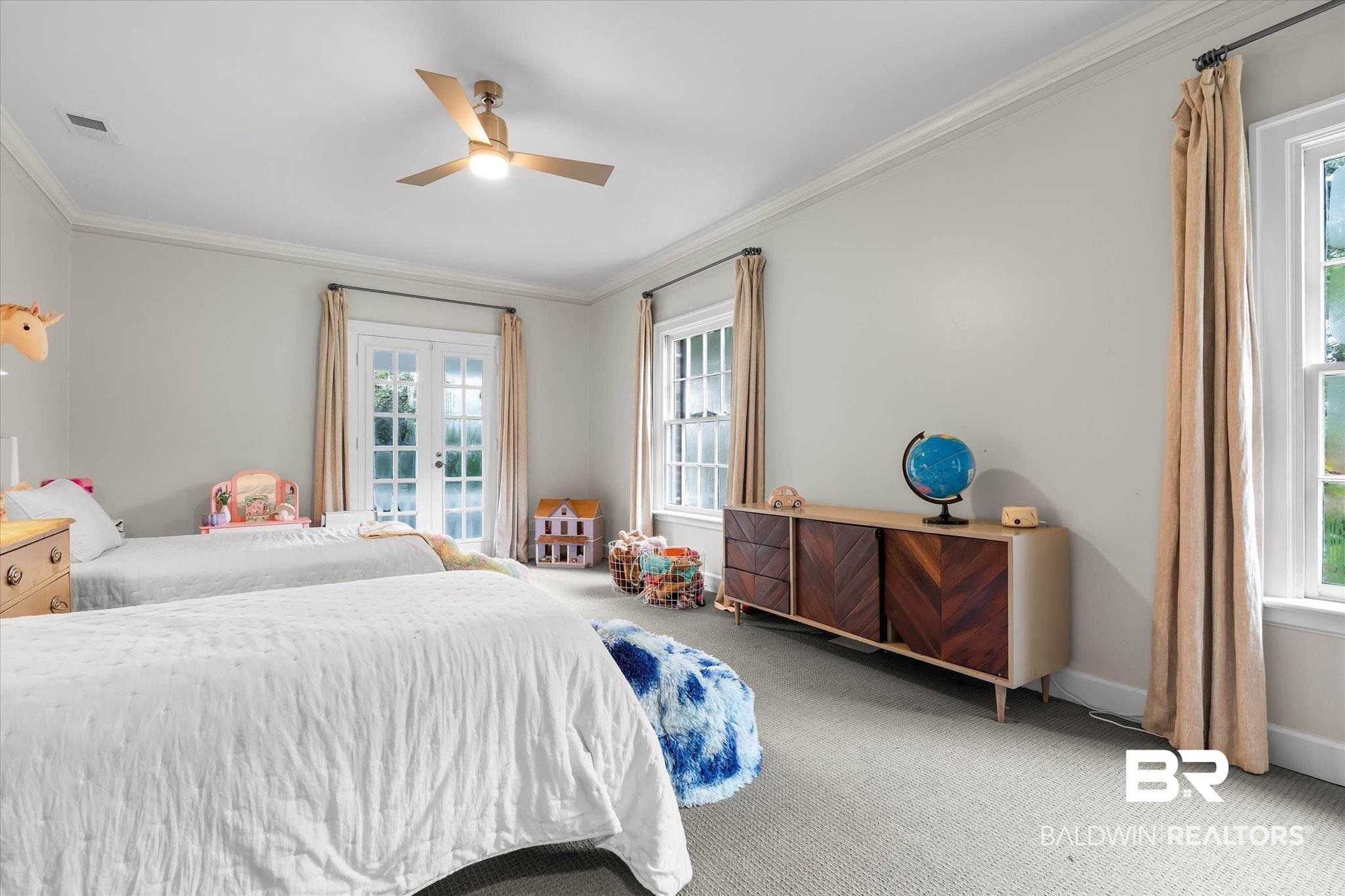 3908 Yester Place Mobile, AL 36608 - Photo 31 of 45 Light-filled room featuring a ceiling fan, crown molding, double French doors, and two large windows