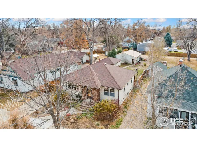 a aerial view of a house with a yard basket ball court and outdoor seating