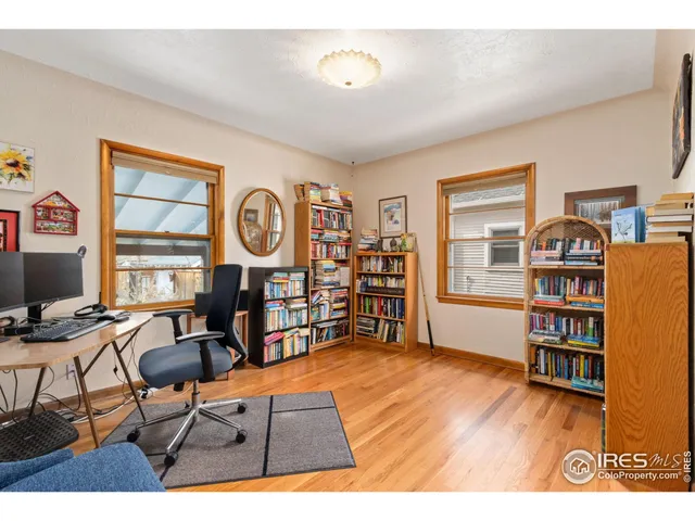 a view of a livingroom with workspace and a window
