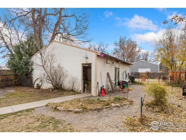 a view of a dirt road with a building