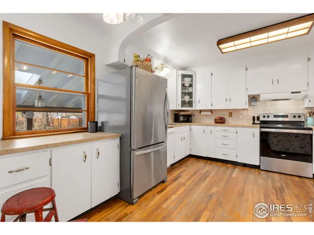 a kitchen with stainless steel appliances granite countertop a refrigerator a stove a sink and a microwave