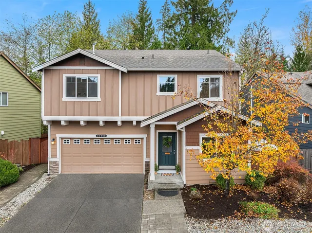 a view of a house with a yard and garage