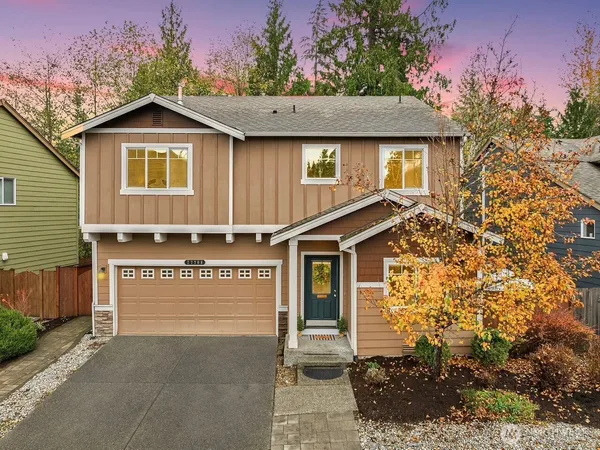 a view of a house with a yard and tree s