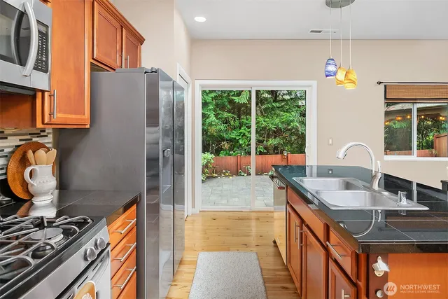a view of backyard with potted plants and a barbeque
