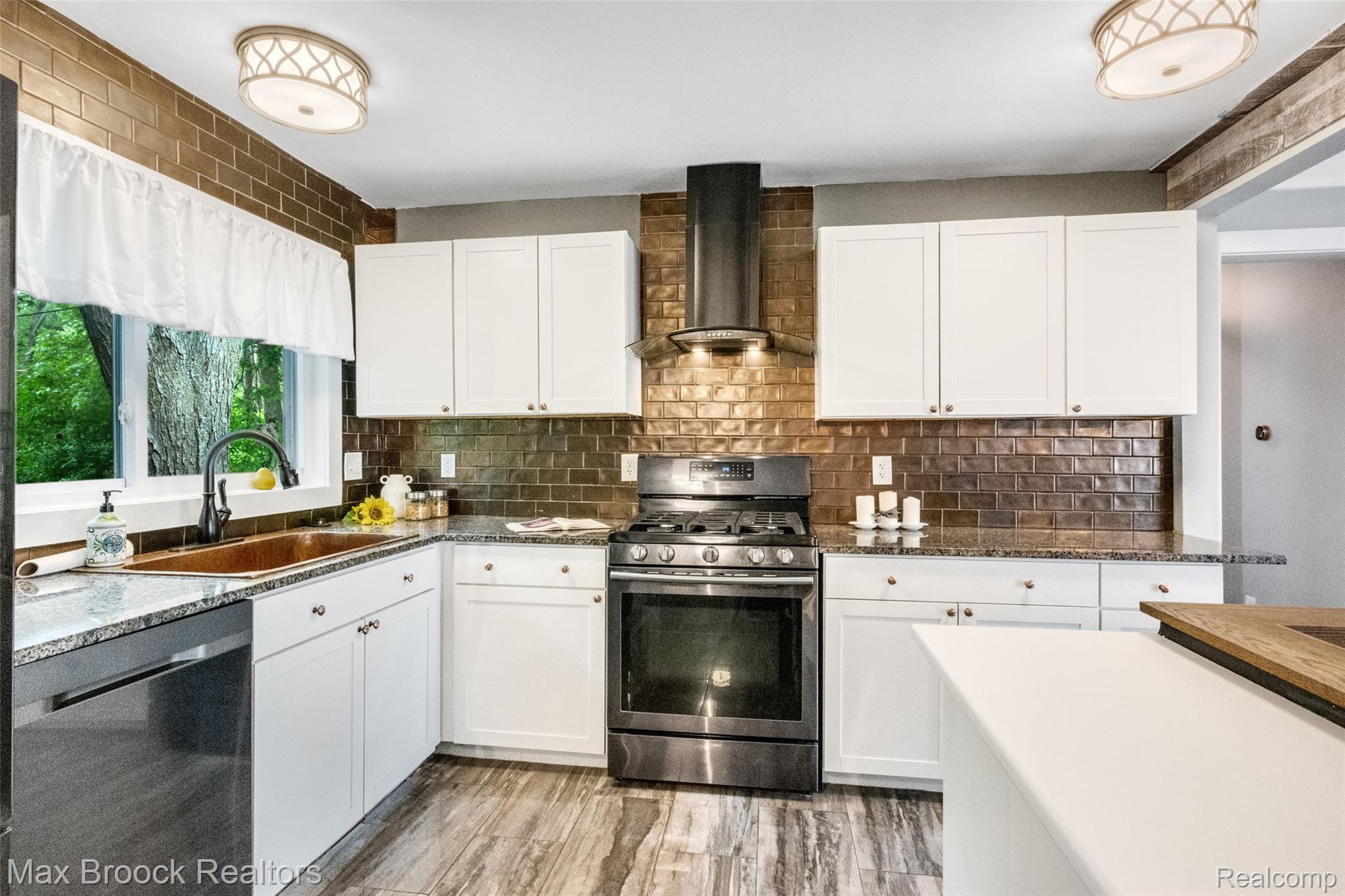 2905 Lahser Road Bloomfield Hills, MI 48304 - Photo 9 of 28 Kitchen featuring white cabinetry, metallic subway tile backsplash, and granite countertops