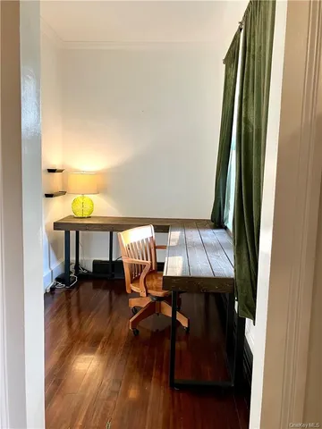 a view of a livingroom with furniture and a window
