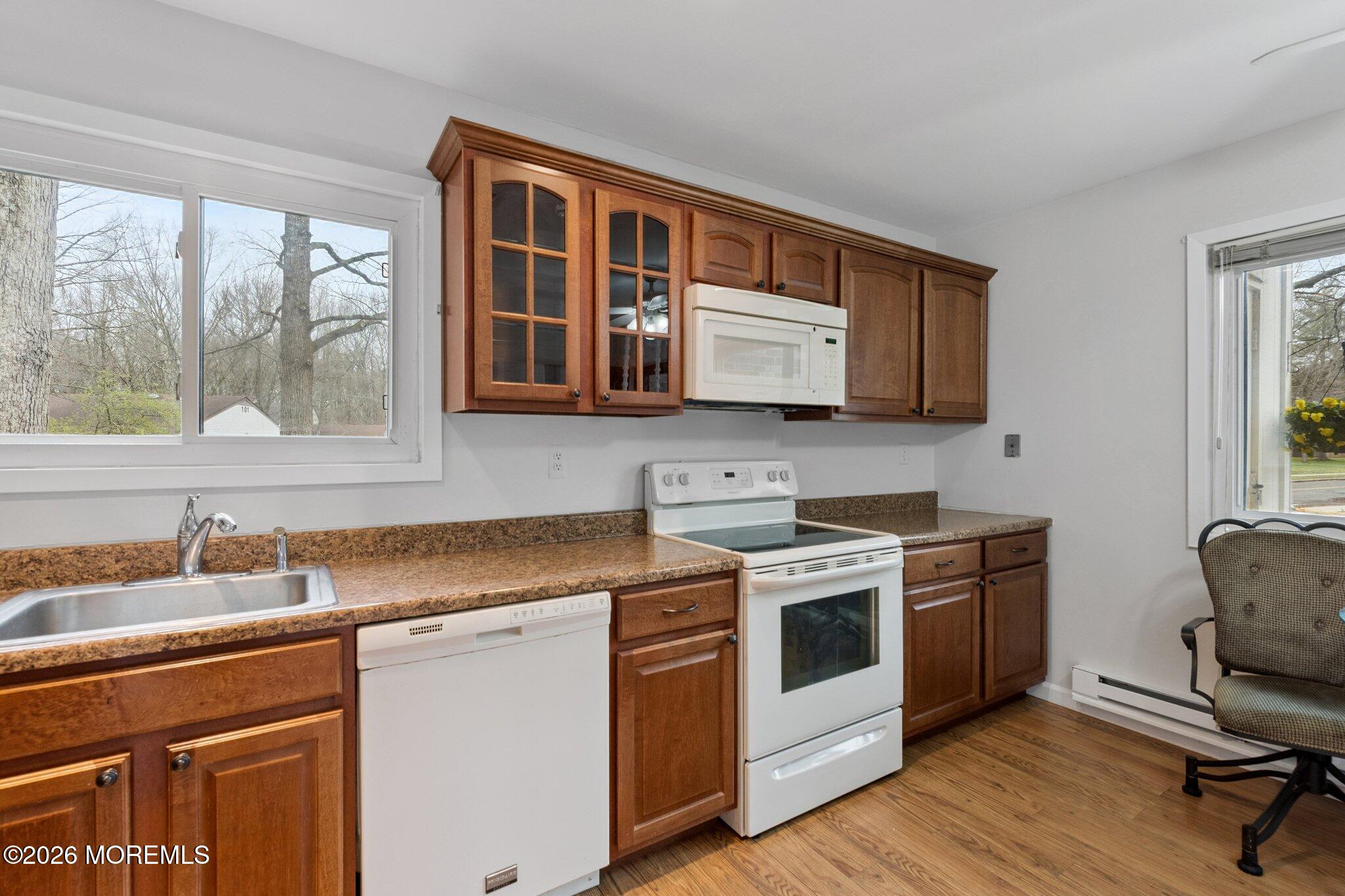 102 Arrowood Road, Unit B Manalapan, NJ 07726 - Photo 12 of 41 a kitchen with stainless steel appliances granite countertop a stove a sink and a microwave