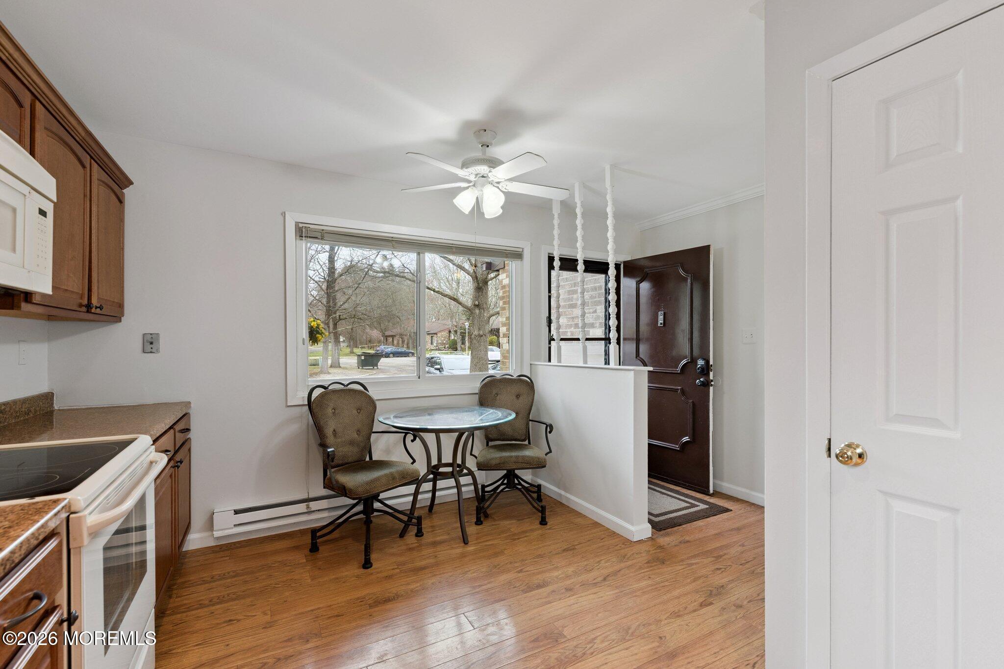 102 Arrowood Road, Unit B Manalapan, NJ 07726 - Photo 13 of 41 a kitchen with stainless steel appliances a dining table chairs and a refrigerator