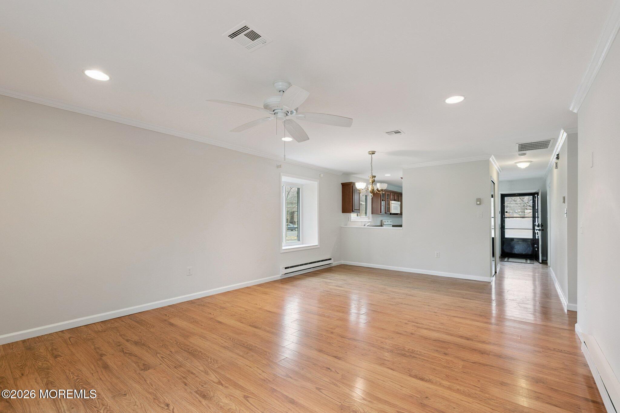 102 Arrowood Road, Unit B Manalapan, NJ 07726 - Photo 15 of 41 a view of an empty room with window and wooden floor