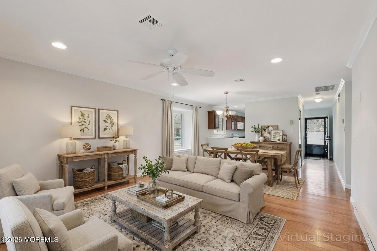102 Arrowood Road, Unit B Manalapan, NJ 07726 - Photo 16 of 41 a living room with furniture a fireplace and a table