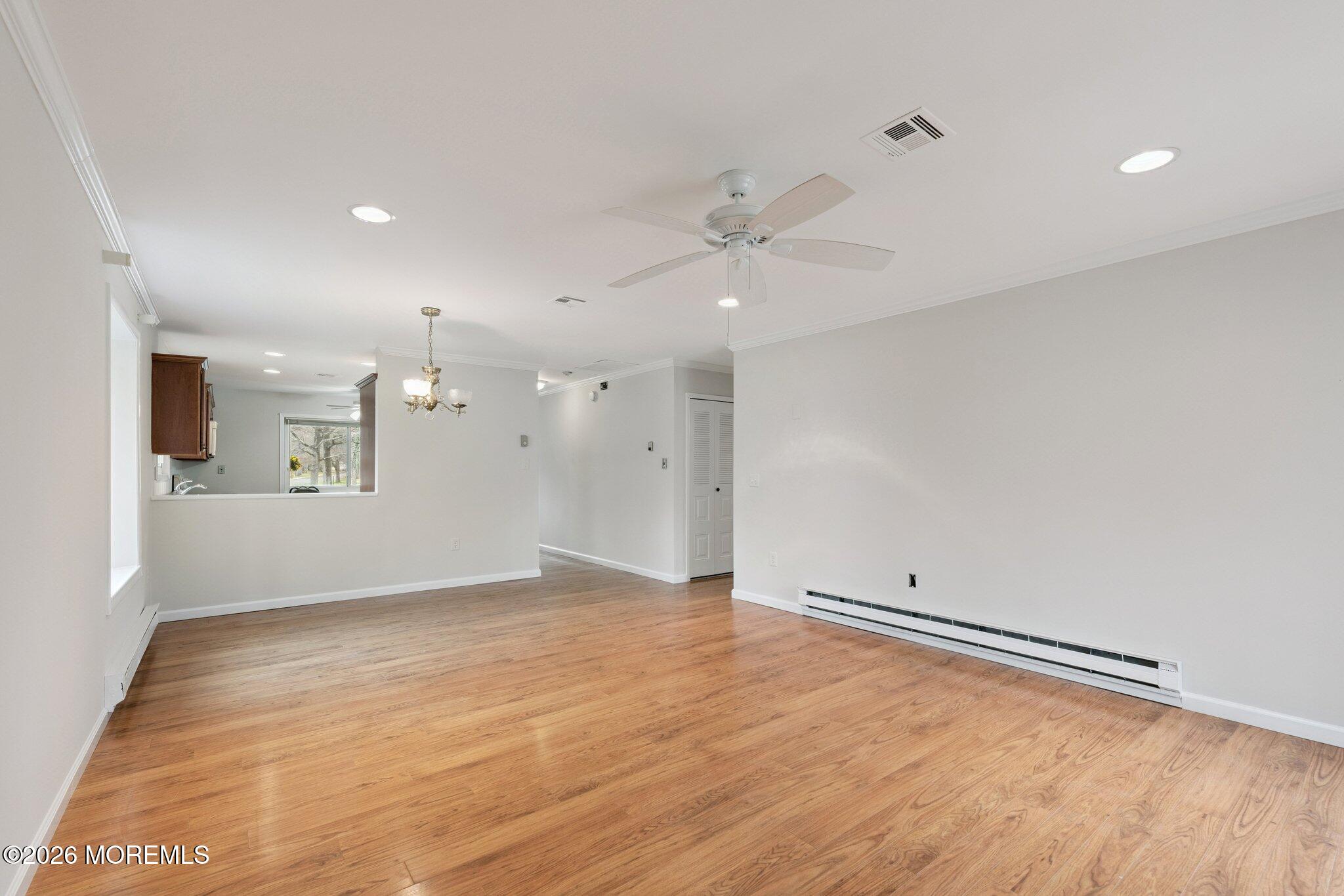102 Arrowood Road, Unit B Manalapan, NJ 07726 - Photo 17 of 41 wooden floor in an empty room with a window