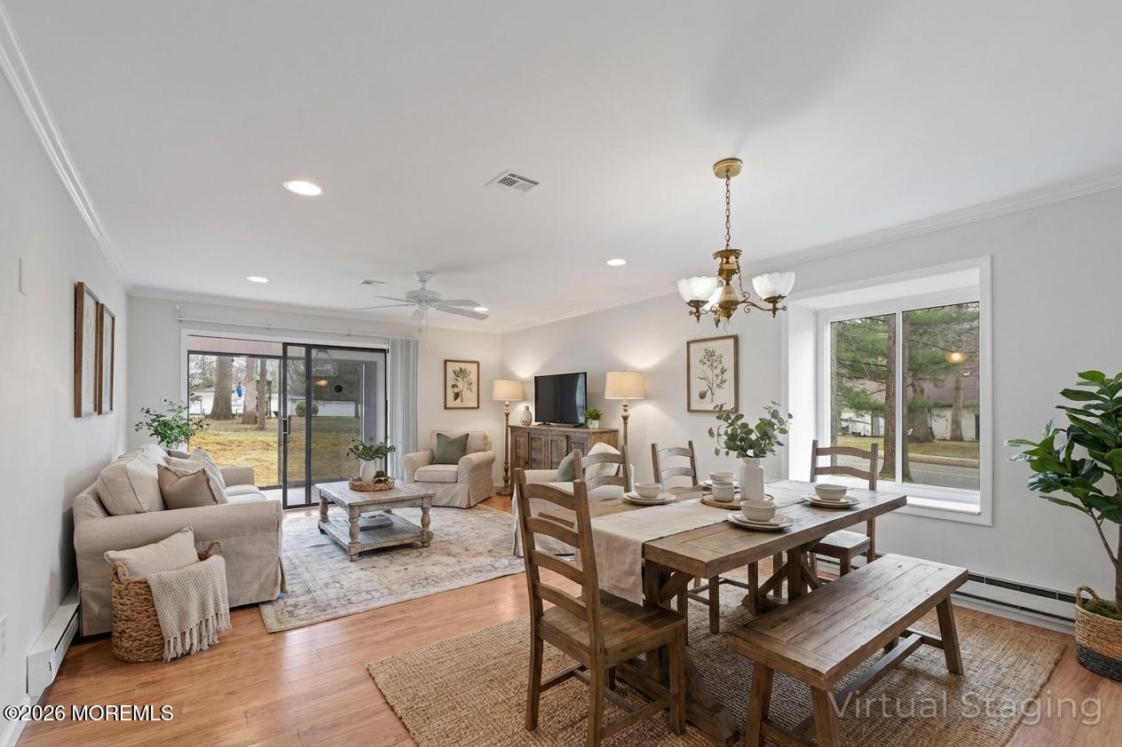 102 Arrowood Road, Unit B Manalapan, NJ 07726 - Photo 20 of 41 a living room with furniture a chandelier and a table