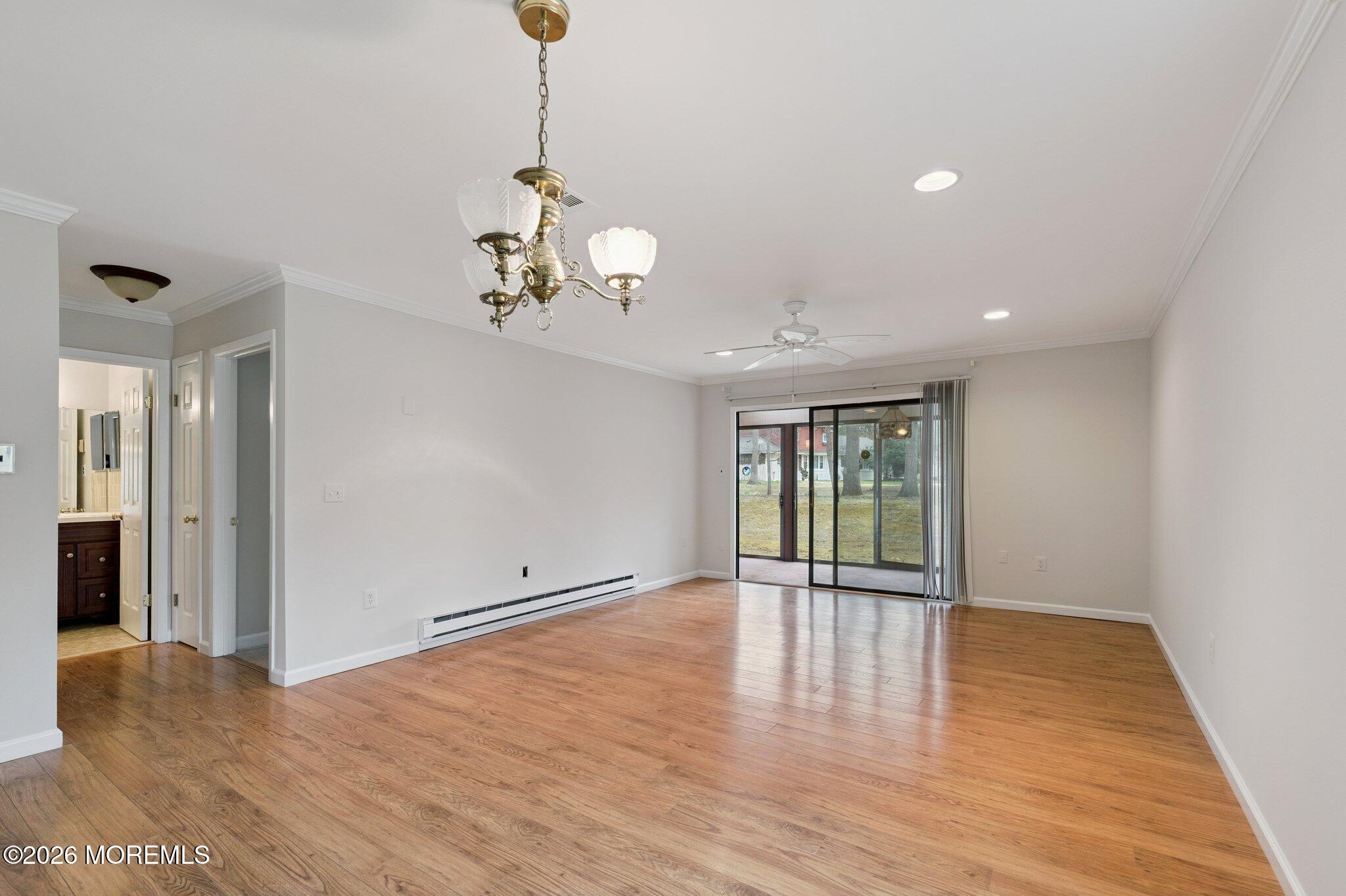 102 Arrowood Road, Unit B Manalapan, NJ 07726 - Photo 21 of 41 a view of an empty room with wooden floor and windows