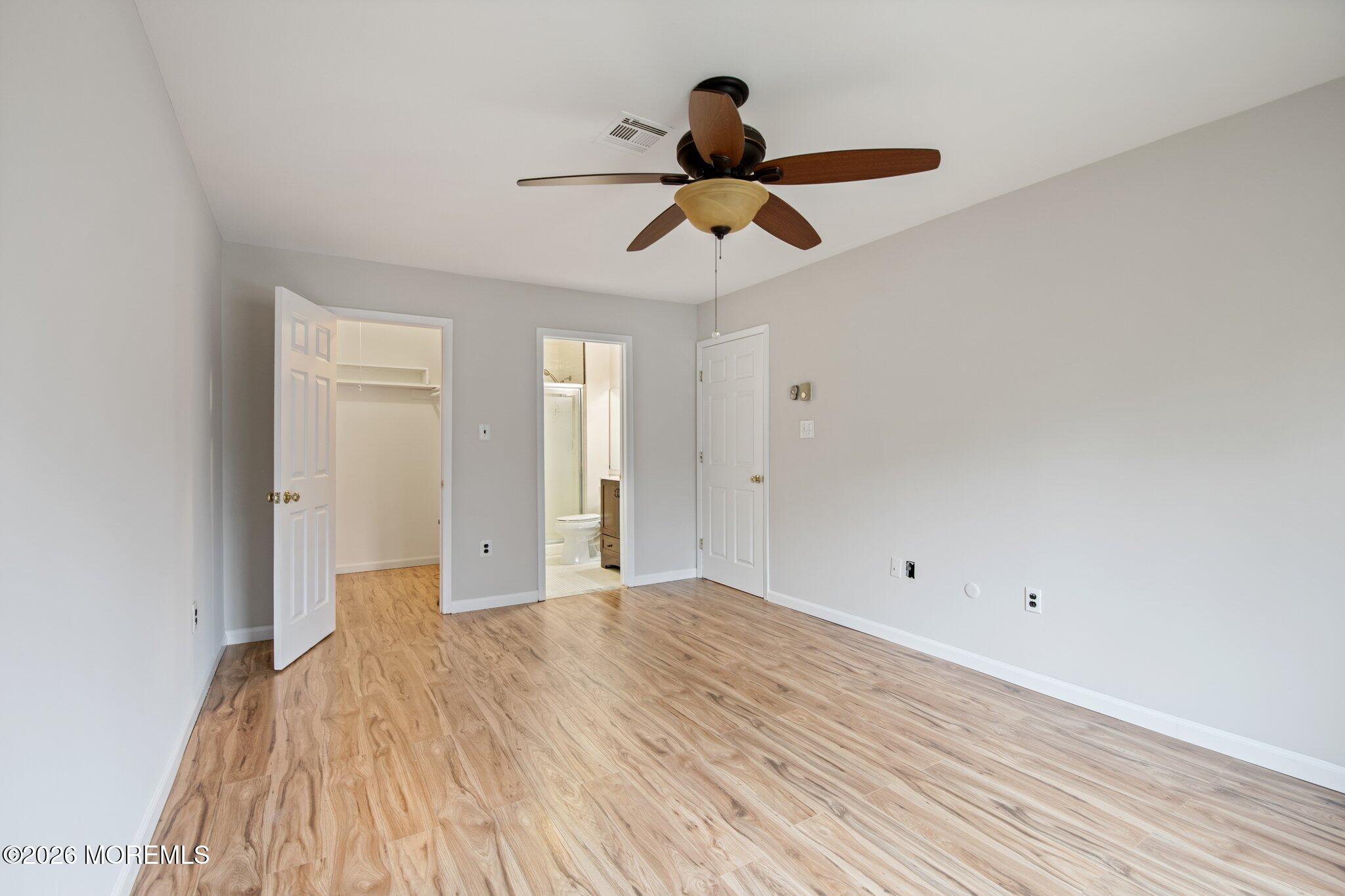 102 Arrowood Road, Unit B Manalapan, NJ 07726 - Photo 26 of 41 a view of empty room with wooden floor