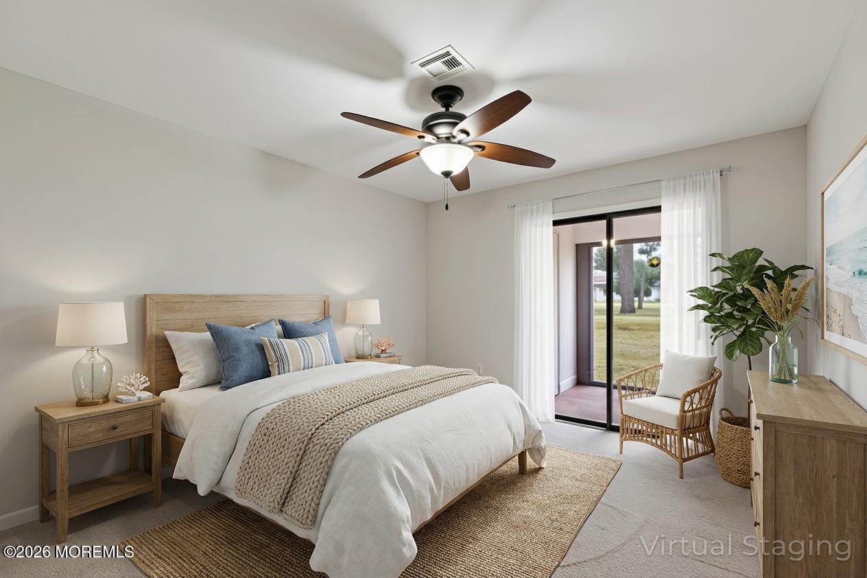 102 Arrowood Road, Unit B Manalapan, NJ 07726 - Photo 31 of 41 a bedroom with a bed and a chandelier