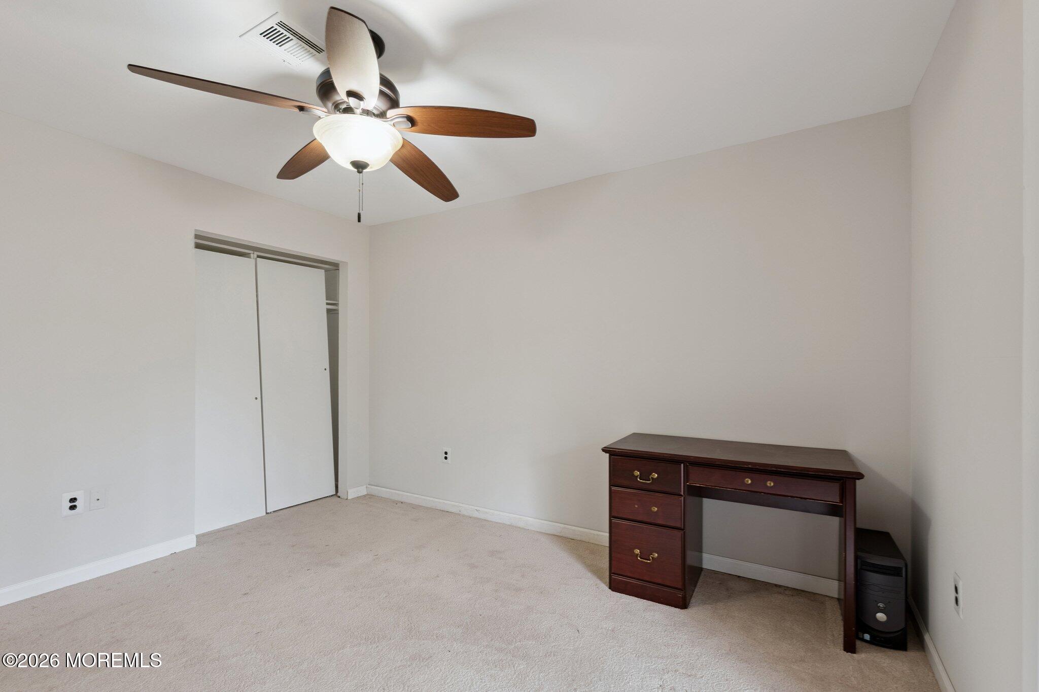 102 Arrowood Road, Unit B Manalapan, NJ 07726 - Photo 33 of 41 a room with a table and a ceiling fan