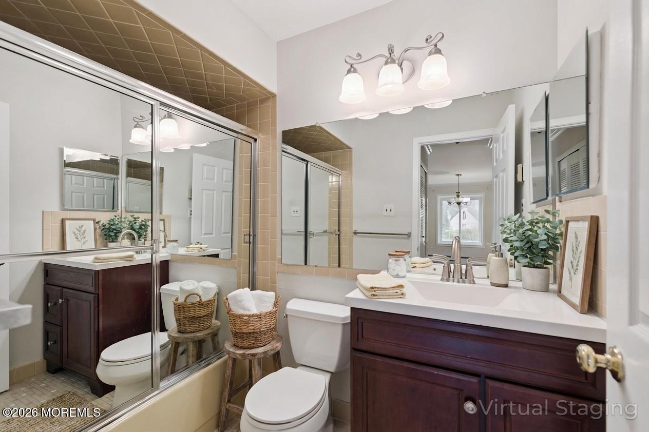 102 Arrowood Road, Unit B Manalapan, NJ 07726 - Photo 36 of 41 a bathroom with a sink vanity mirror and toilet