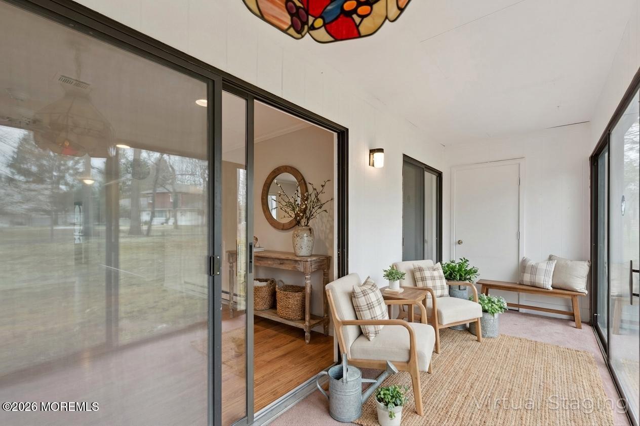 102 Arrowood Road, Unit B Manalapan, NJ 07726 - Photo 38 of 41 a living room with furniture a rug and white walls
