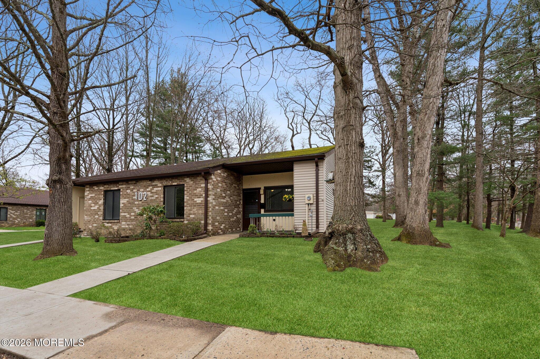 102 Arrowood Road, Unit B Manalapan, NJ 07726 - Photo 5 of 41 a view of a house with a yard