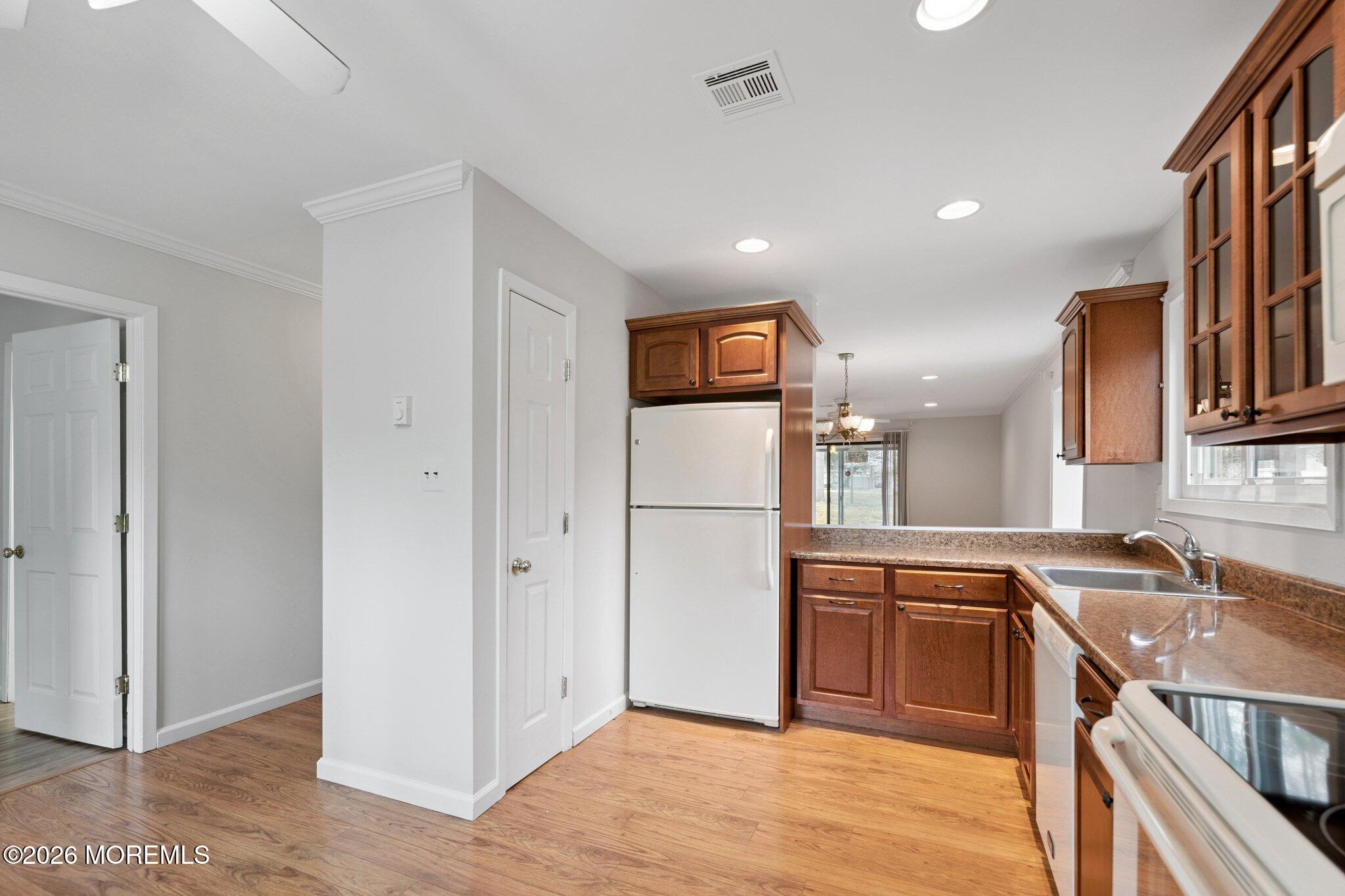 102 Arrowood Road, Unit B Manalapan, NJ 07726 - Photo 7 of 41 a kitchen with a refrigerator sink and cabinets