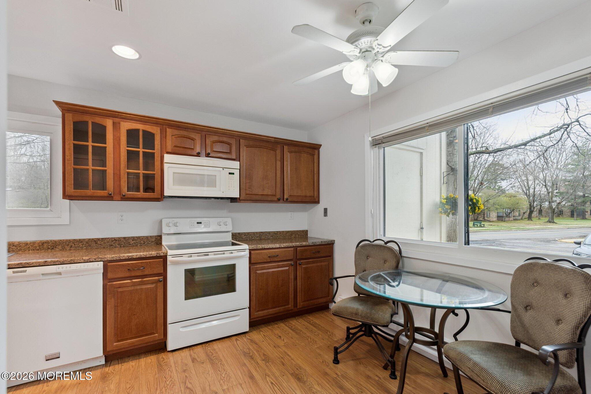 102 Arrowood Road, Unit B Manalapan, NJ 07726 - Photo 10 of 41 a kitchen with a stove a sink and chairs