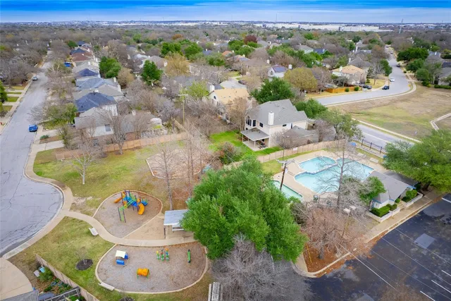 a view of a lake with a yard and large trees