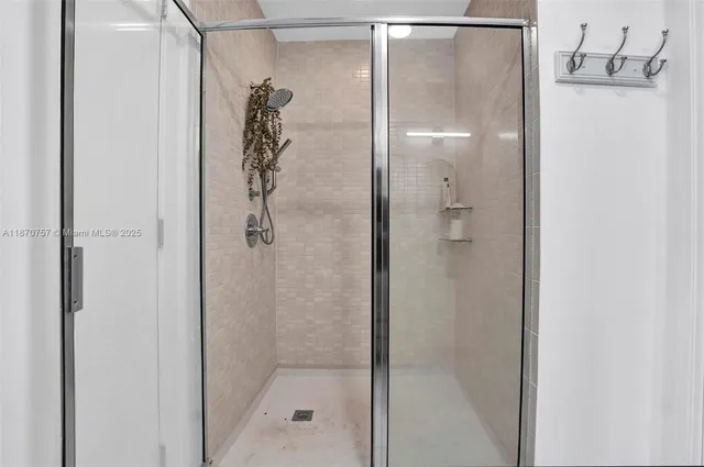 a bathroom with a glass shower door