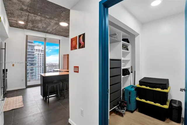 a view of a porch with furniture and floor to ceiling window