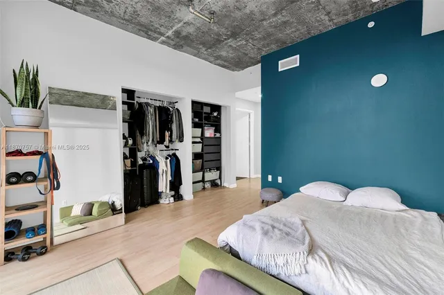 a bedroom with a bed and a walk in closet