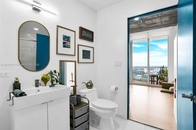 a bathroom with a toilet a sink and a mirror