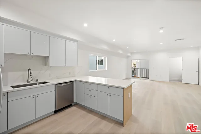a kitchen with sink and cabinets