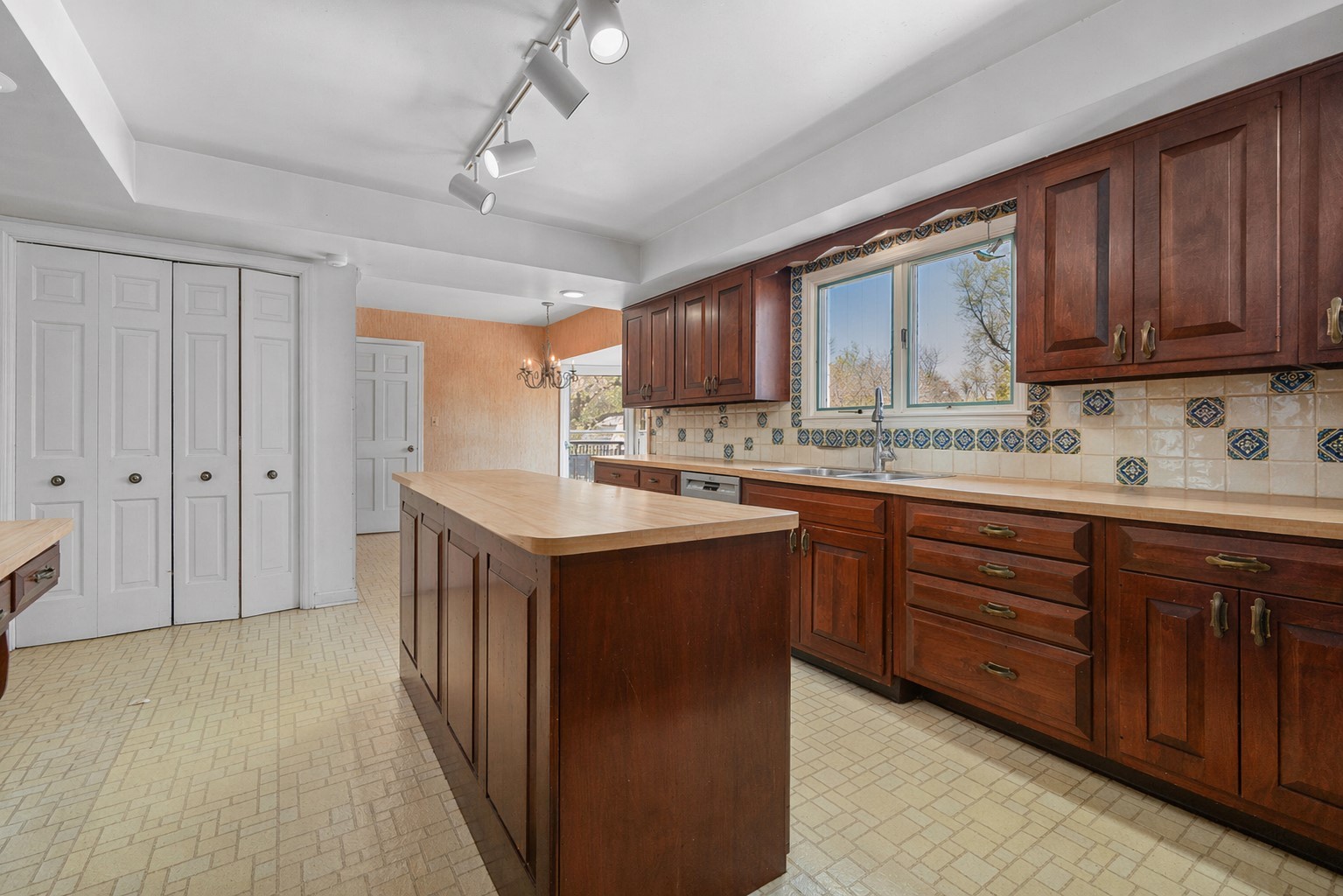 37 Forest Hills Road Lake Bluff, IL 60044 - Photo 15 of 52 a kitchen with kitchen island granite countertop wooden cabinets stainless steel appliances a sink and a window