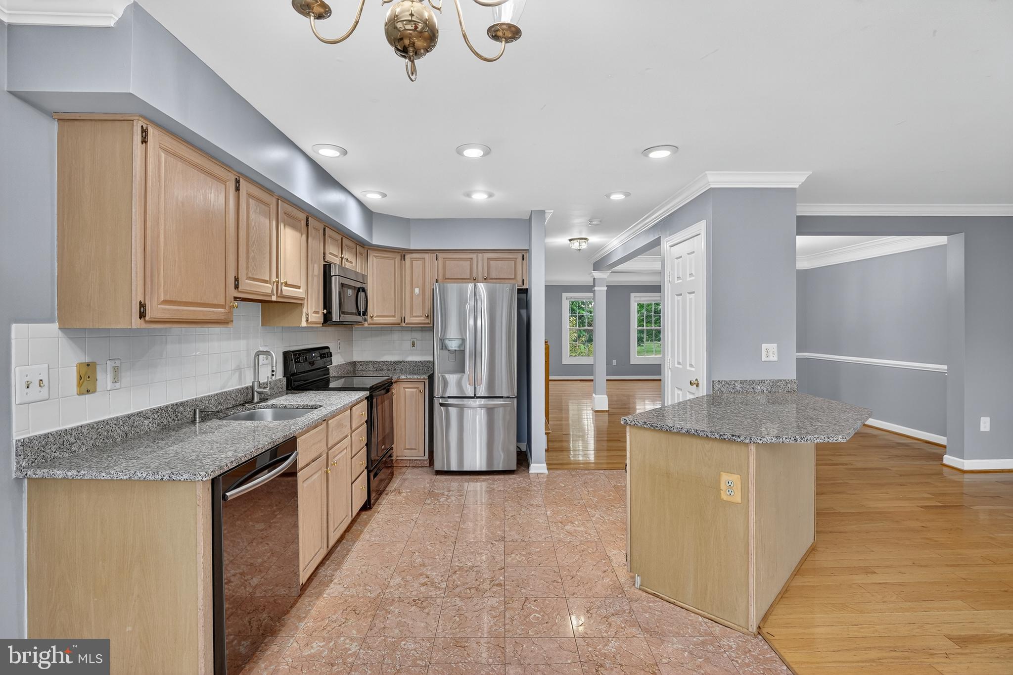 6319 Powder Flask Court Centreville, VA 20121 - Photo 18 of 31 a kitchen with stainless steel appliances granite countertop a sink stove and refrigerator