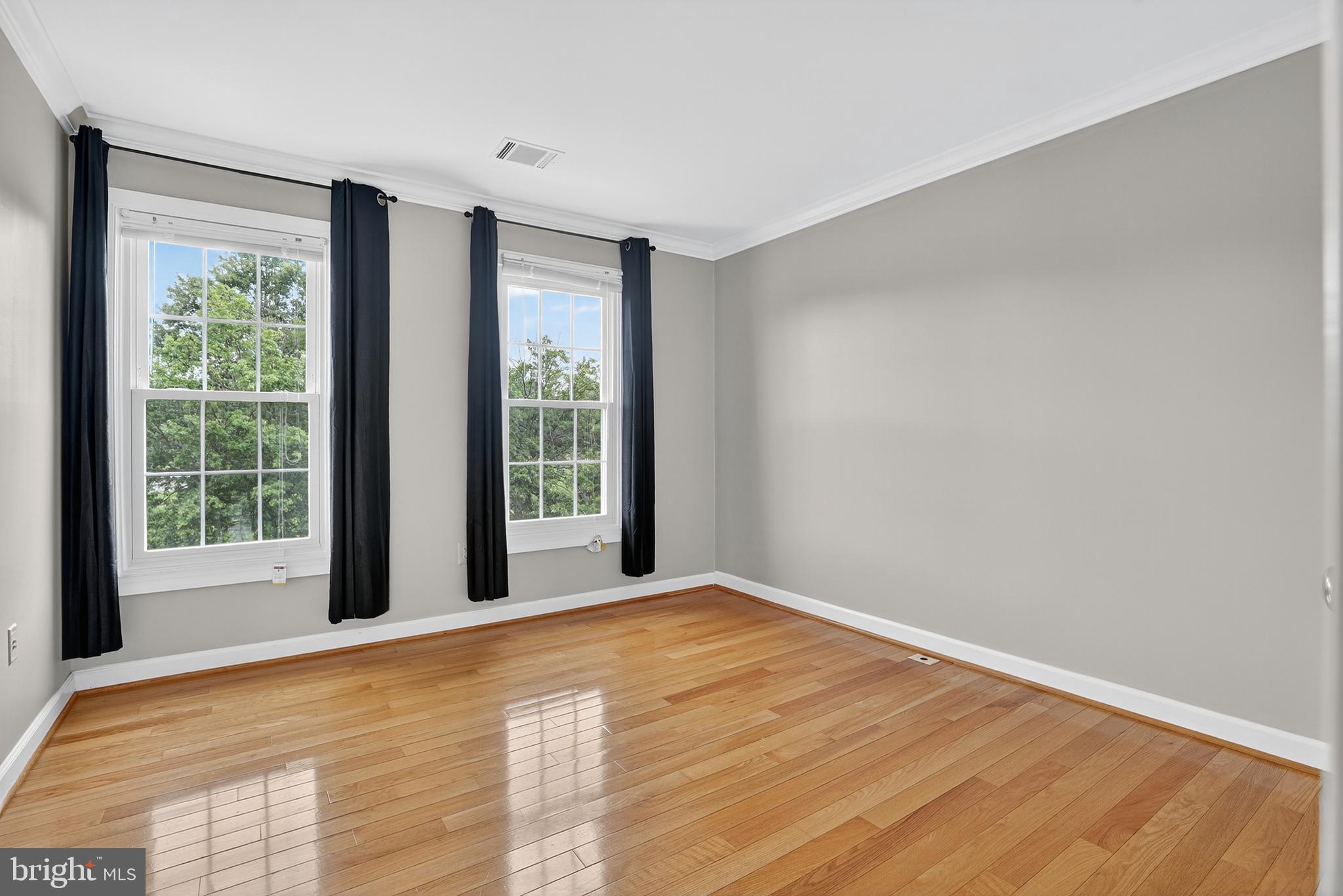 6319 Powder Flask Court Centreville, VA 20121 - Photo 23 of 31 a view of an empty room with wooden floor and a window