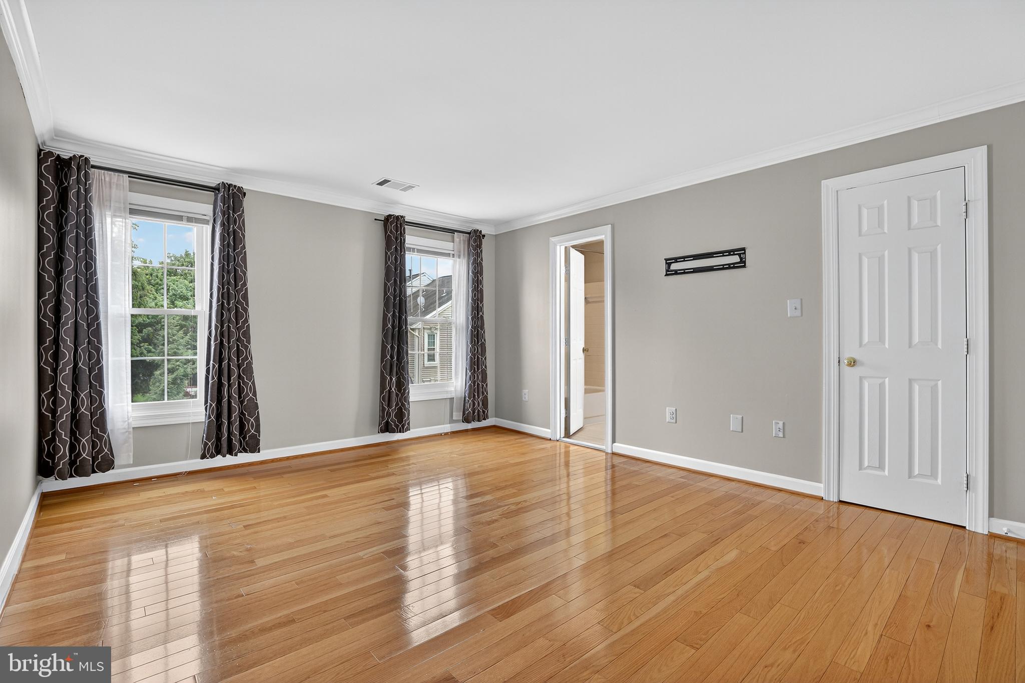 6319 Powder Flask Court Centreville, VA 20121 - Photo 25 of 31 a view of an empty room with wooden floor and a window