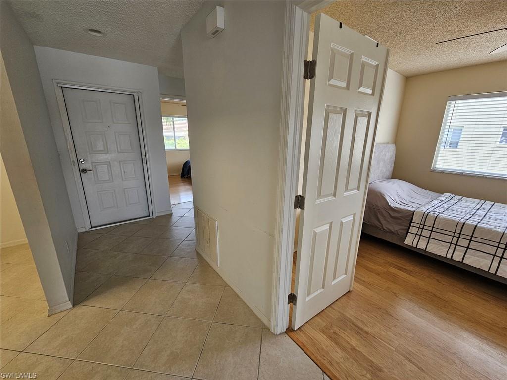 7766 Emerald Circle, Unit R201 Naples, FL 34109 - Photo 19 of 35 a view of a bedroom with furniture and window