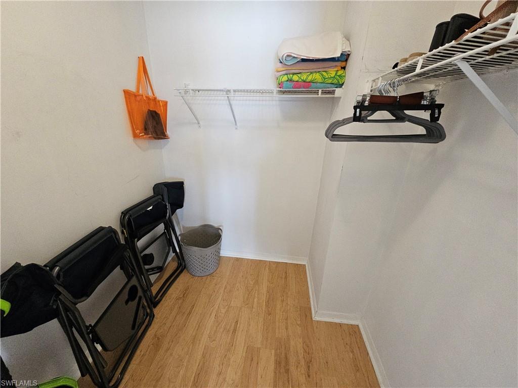 7766 Emerald Circle, Unit R201 Naples, FL 34109 - Photo 20 of 35 a bathroom with a sink and a mirror