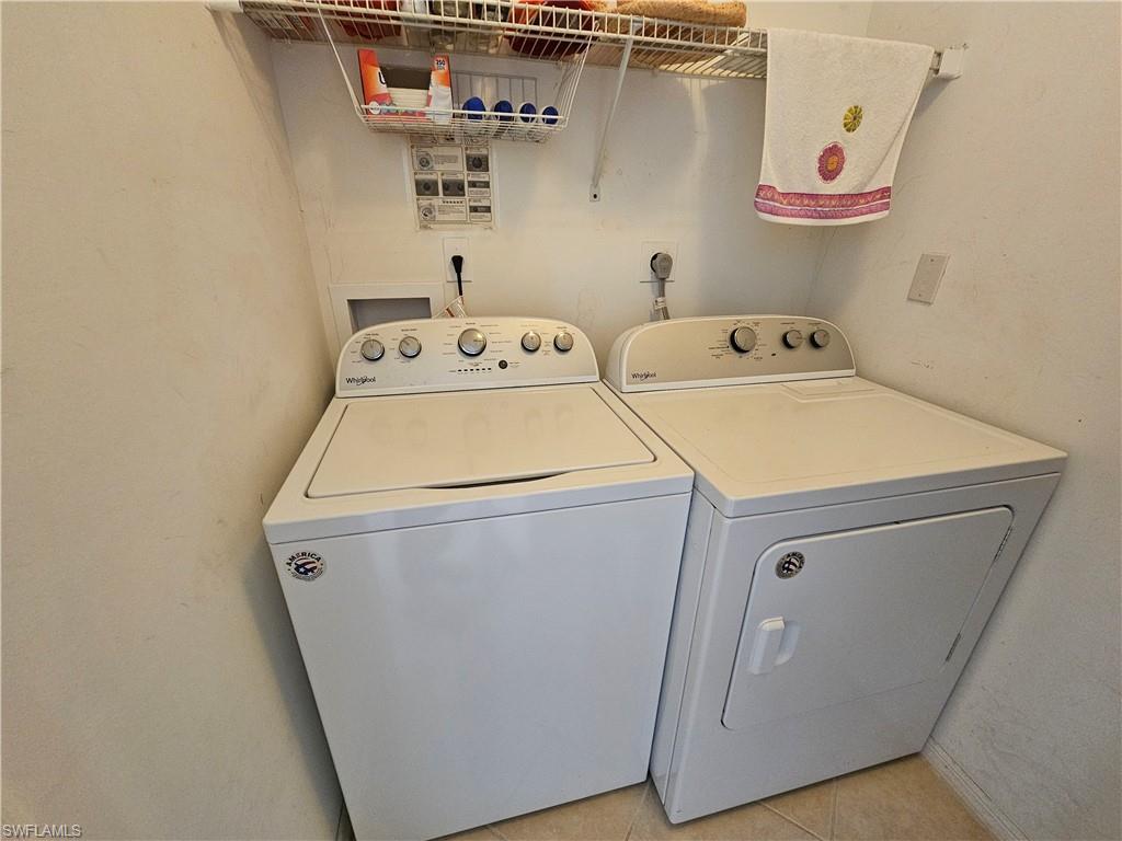 7766 Emerald Circle, Unit R201 Naples, FL 34109 - Photo 22 of 35 a utility room with dryer and washer