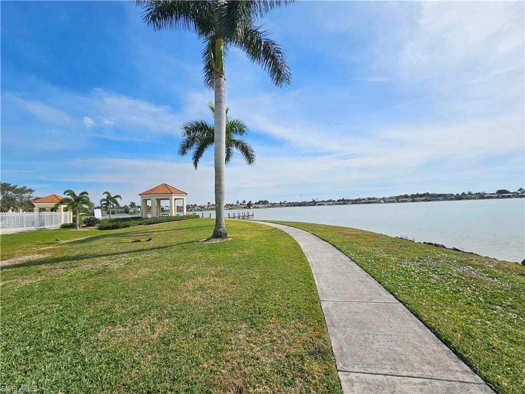7766 Emerald Circle, Unit R201 Naples, FL 34109 - Photo 25 of 35 a view of a lake with a big yard