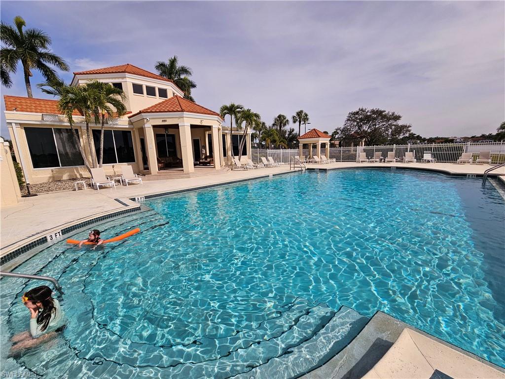 7766 Emerald Circle, Unit R201 Naples, FL 34109 - Photo 26 of 35 a front view of a house with a yard