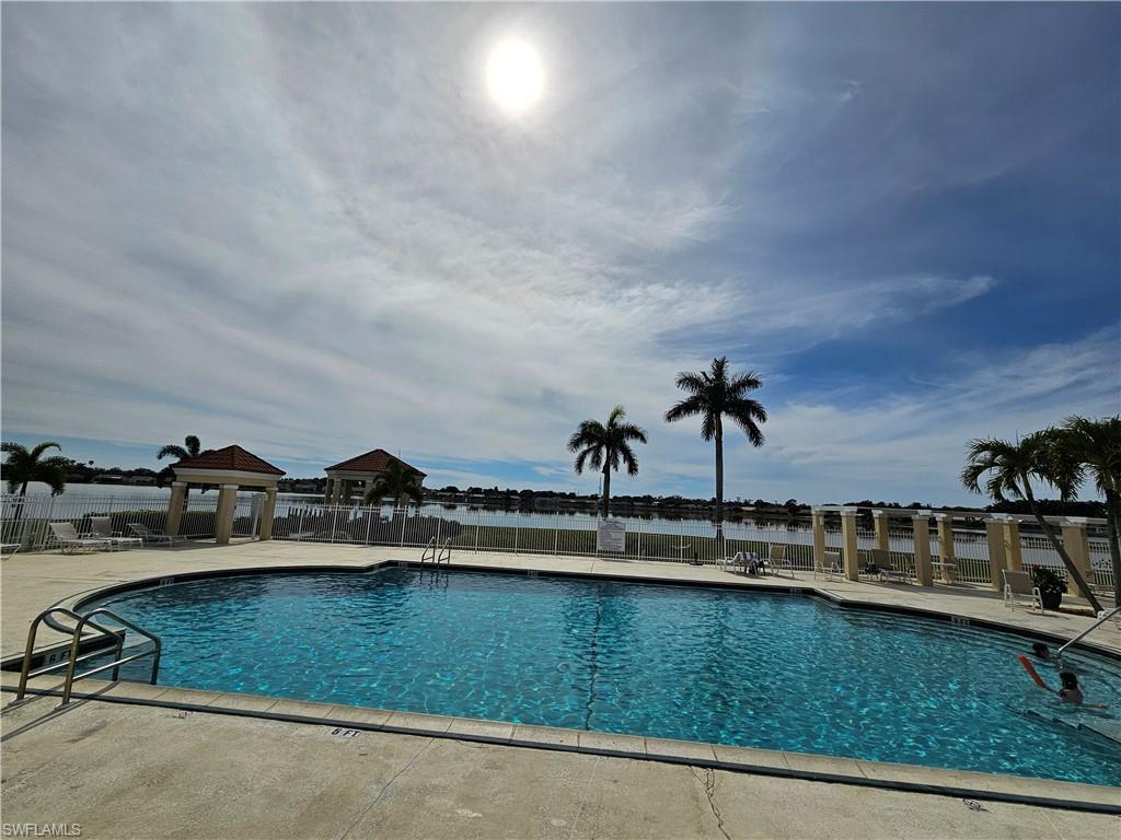 7766 Emerald Circle, Unit R201 Naples, FL 34109 - Photo 28 of 35 a view of a swimming pool with a yard