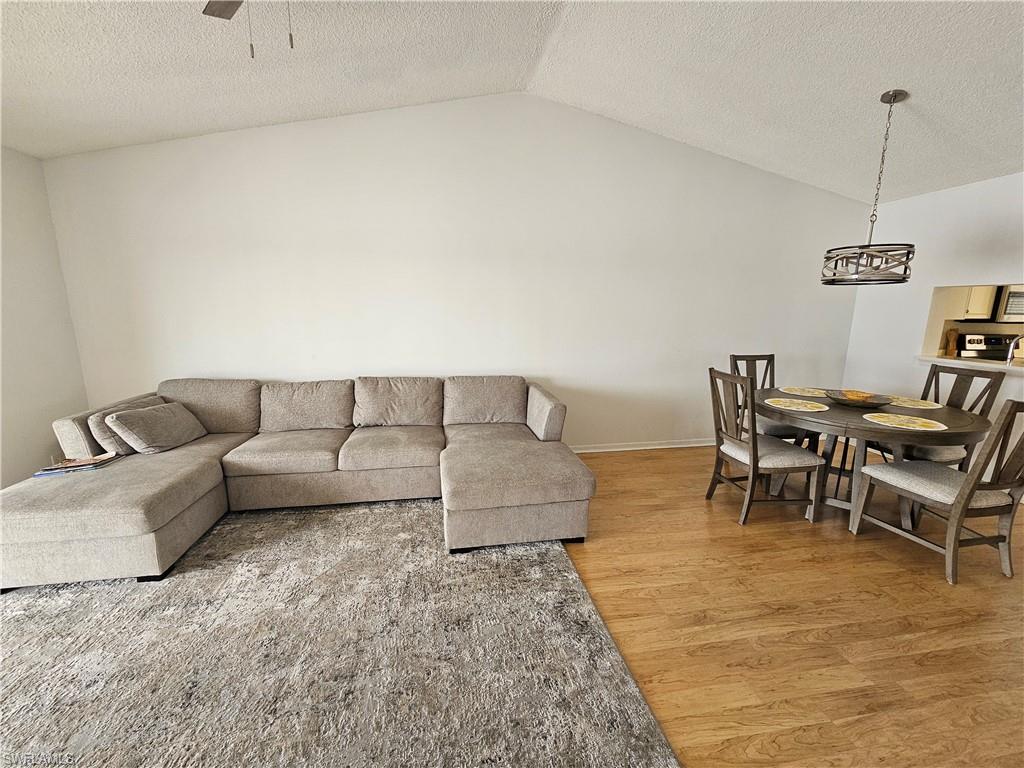 7766 Emerald Circle, Unit R201 Naples, FL 34109 - Photo 7 of 35 a living room with furniture and a couch