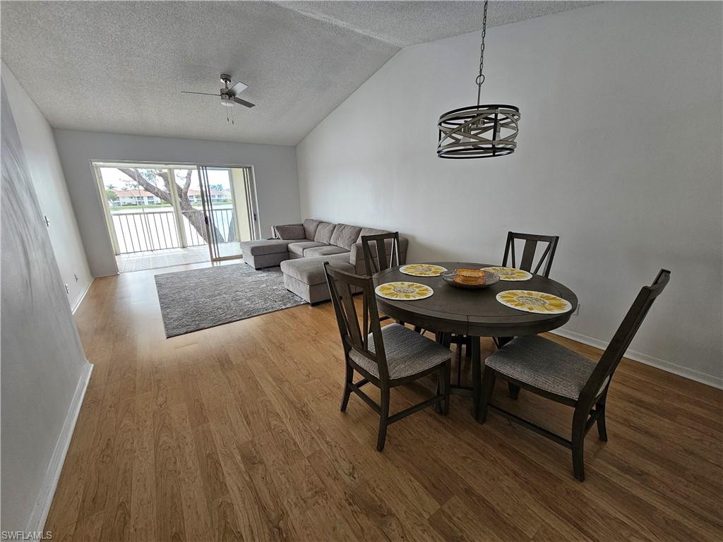 7766 Emerald Circle, Unit R201 Naples, FL 34109 - Photo 10 of 35 a view of a dining room with furniture window and wooden floor