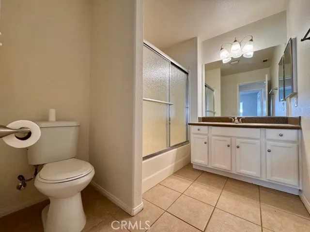a spacious bathroom with a toilet sink and mirror