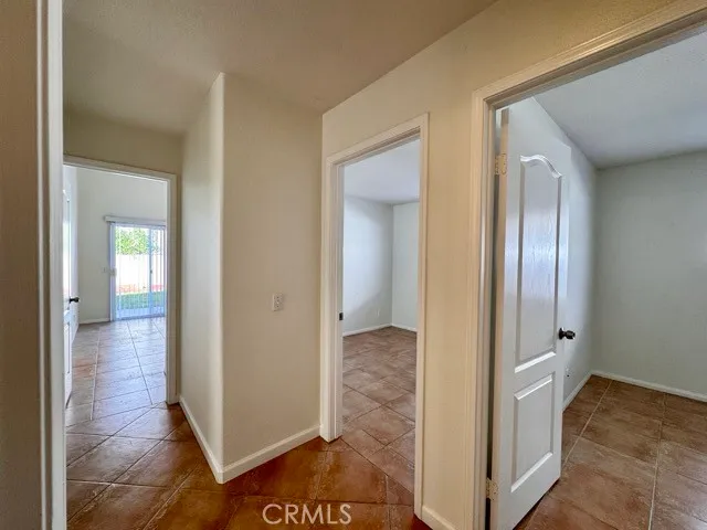wooden floor with a bedroom and mirror