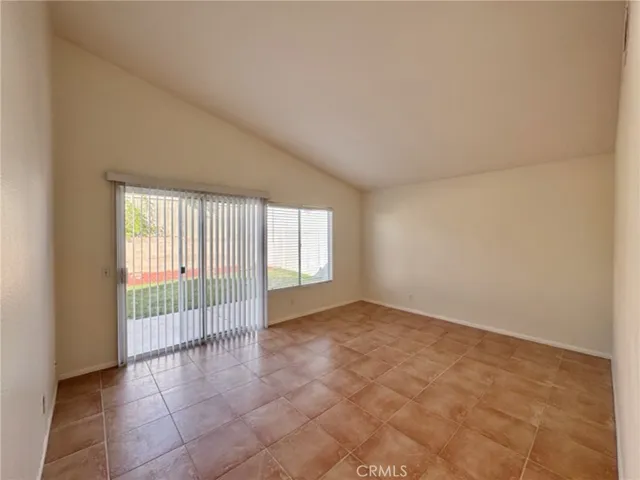 an empty room with windows and mirror