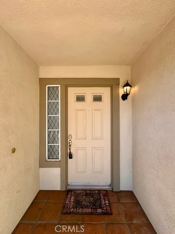 a view of a livingroom with wooden floor and white walls